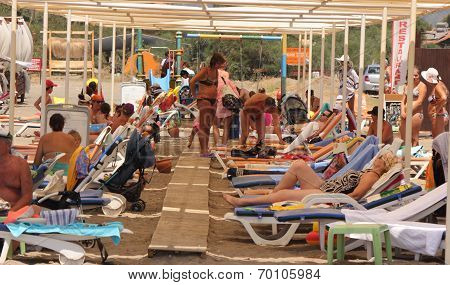 Tourists sunbathing on the beach