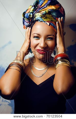 beauty bright african with creative make up, shawl on head like cubian woman