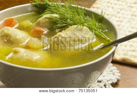 Delicious Matzoh ball soup with crackers wine and dill