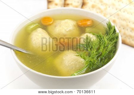 Delicious Matzoh ball soup with crackers wine and dill