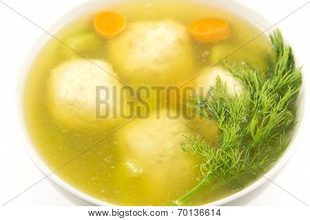 Delicious Matzoh ball soup with crackers wine and dill