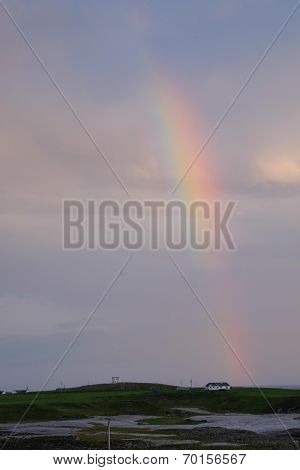 House beneath rainbow