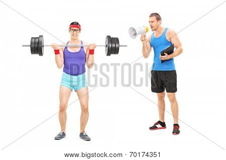 Fitness coach shouting at a nerdy guy through megaphone isolated on white background