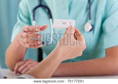 Woman With Pregnancy Test And Gynecologist