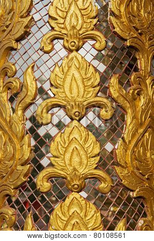 wall carving art with stained glass Wat-Grang-Suan-Dok-Mai Buddhist temple northern of Thailand.