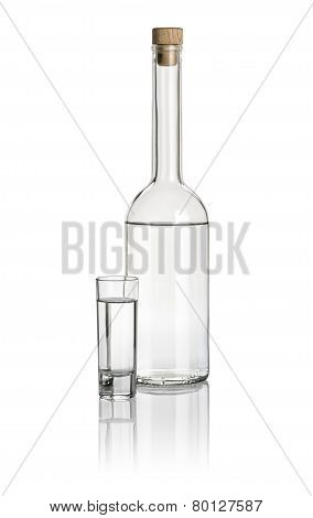 Liquor bottle and high shot glass filled with clear liquid