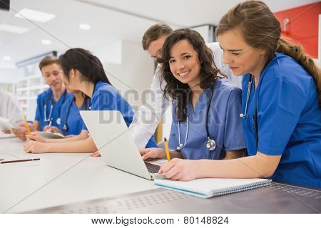Medical student smiling at the camera during class at the university
