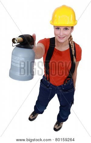 Blond woman holding blow torch