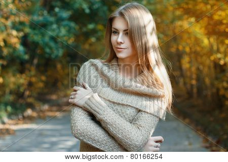 Beautiful Girl In A Sweater Standing In Autumn Park