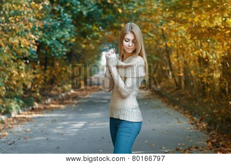 Cute Woman In A Jersey Standing In Autumn Park