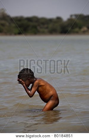 The African Boy Washing In The River.