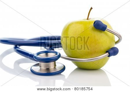 an apple and a stethoscope with a doctor. symbolic photo for healthy, vitamin-rich diet.