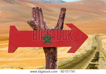 Marocco Flag wooden sign with desert road background