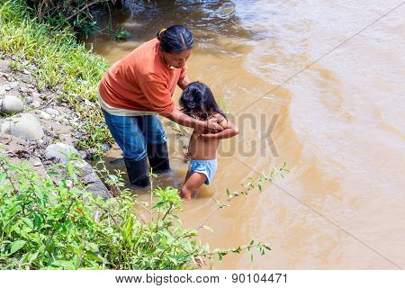 Yasuni, Ecuador - 17 November 2012: Indigenous Family, Mother And Daughter, Bath Time In Amazon River, South America In Yasuni On November 17, 2012