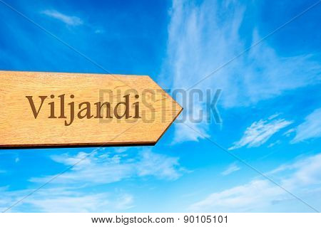 Wooden arrow sign pointing touristic destination