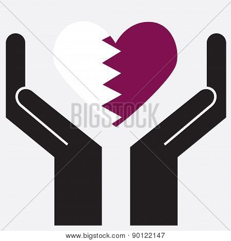 Hand showing Qatar flag in a heart shape.