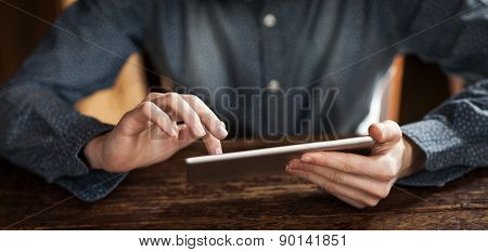 Young Man Using A Touch Screen Tablet