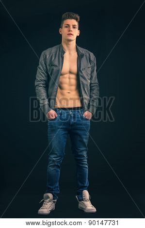 Full length shot of young man wearing jacket on naked torso