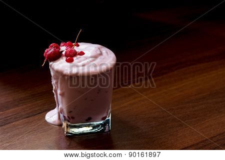 Delicious Fruit Yougurt With Berries Spilled On The Table