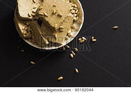 Sunflower Halva With Seeds On Plate, On Black Background