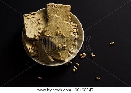 Sunflower Halva With Seeds On Plate, On Black Background