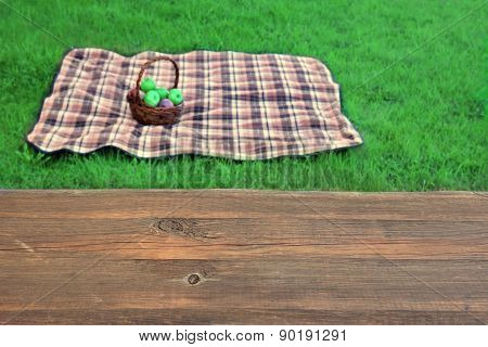 Empty Picnic Table Close-up Blanket With Basket In The Background