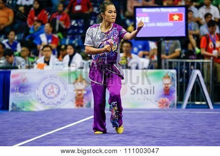 JAKARTA, INDONESIA - NOVEMBER 15, 2015: Thuy Linh Nguyen of Vietnam performs the movements in the women's Nanquan event at the 13th World Wushu Championship 2015 held in Istora Senayan, Jakarta.