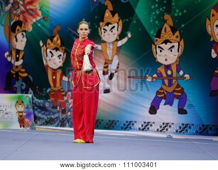 JAKARTA, INDONESIA - NOVEMBER 15, 2015: Liudmyla Temna of Ukraine performs the movements in the women's Shuangjian event at the 13th World Wushu Championship 2015 held in Istora Senayan, Jakarta.