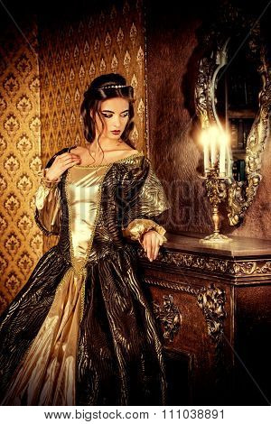 Renaissance Style -  beautiful young woman in the lush expensive dress in an old palace interior. Vintage style. Fashion.