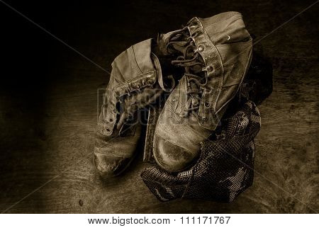 Still life with old jungle boot on iron bullet box