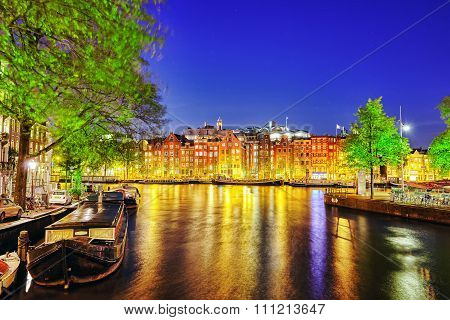 Famous Amstel River And Night View Of Beautiful Amsterdam City. Netherlands
