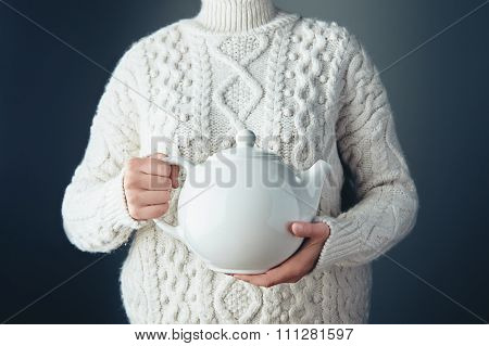 Big White Teapot With Tea In Hands On Air