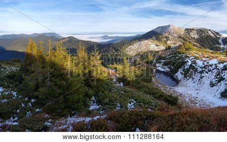 Landscape with a frozen lake. Offseason in the mountains. Carpathians, Ukraine, Europe