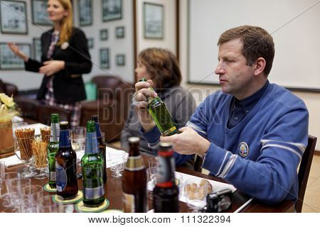 ST. PETERSBURG, RUSSIA - OCTOBER 24, 2015: Tourists during tasting session at the Baltika - St Petersburg brewery. This session is a part of the October Beer Festival celebrations