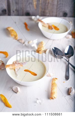 Garlic cream soup on white background