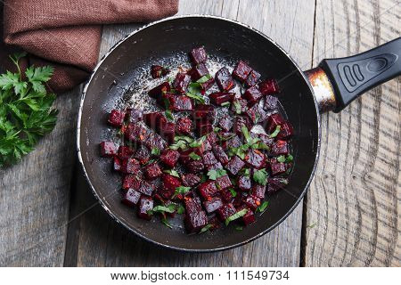 Cooked beets sliced and fried in a pan
