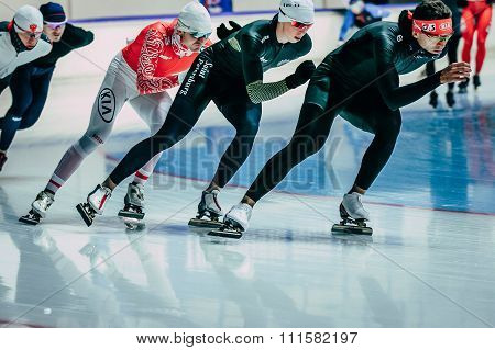 group men speedskater warming up before start