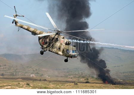 Helicopters Mounting A Ground Attack With Explosions And Smoke