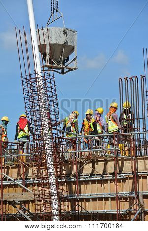 Group of construction workers concreting slab at the construction site