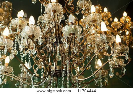 Beautiful vintage crystal chandelier in a room, Golden tones.