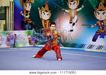 JAKARTA, INDONESIA - NOVEMBER 17, 2015: Wong Weng Son of Malaysia performs the movements in the men's Compulsory Changquan event in the 13th World Wushu Championship 2015 in Istora Senayan Stadium.