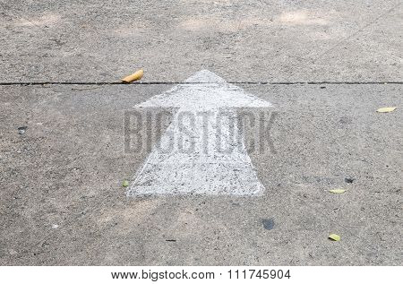 Closeup White Painted Arrow Sign On Cement Street Floor Background