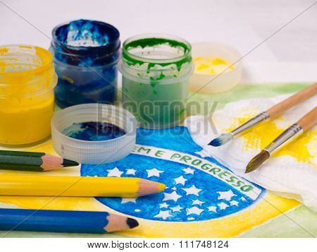 Paints,brushes And Color Pencils On The Brazil Flag Watercolor Painting