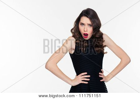 Shoked disturbed pretty young woman with bright makeup in retro style in black dress isolated over white background