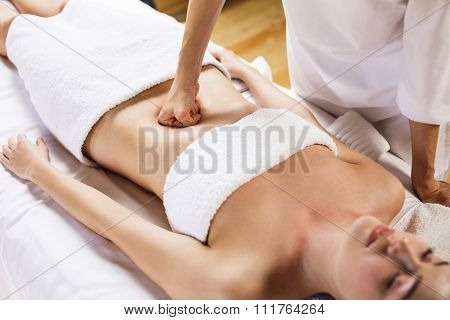 Woman having abdomen massage.