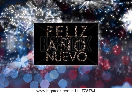 Glittering feliz ano nuevo against colourful fireworks exploding on black background