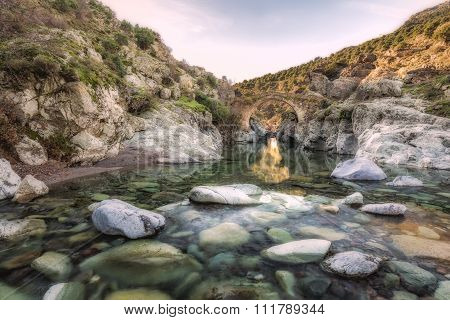 River Passing Through Genoese Bridge At Asco In Corsica