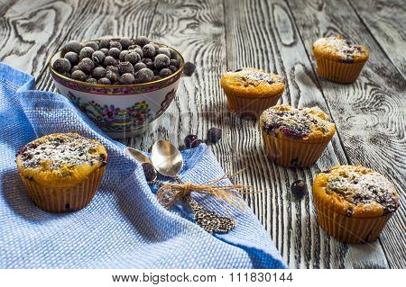 Five muffins with black currants front view, horizontal frame