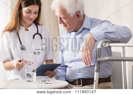 Nurse Giving Her Patient Medicines