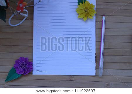 Writing Paper And Pen Placed On A Wooden Brown Background